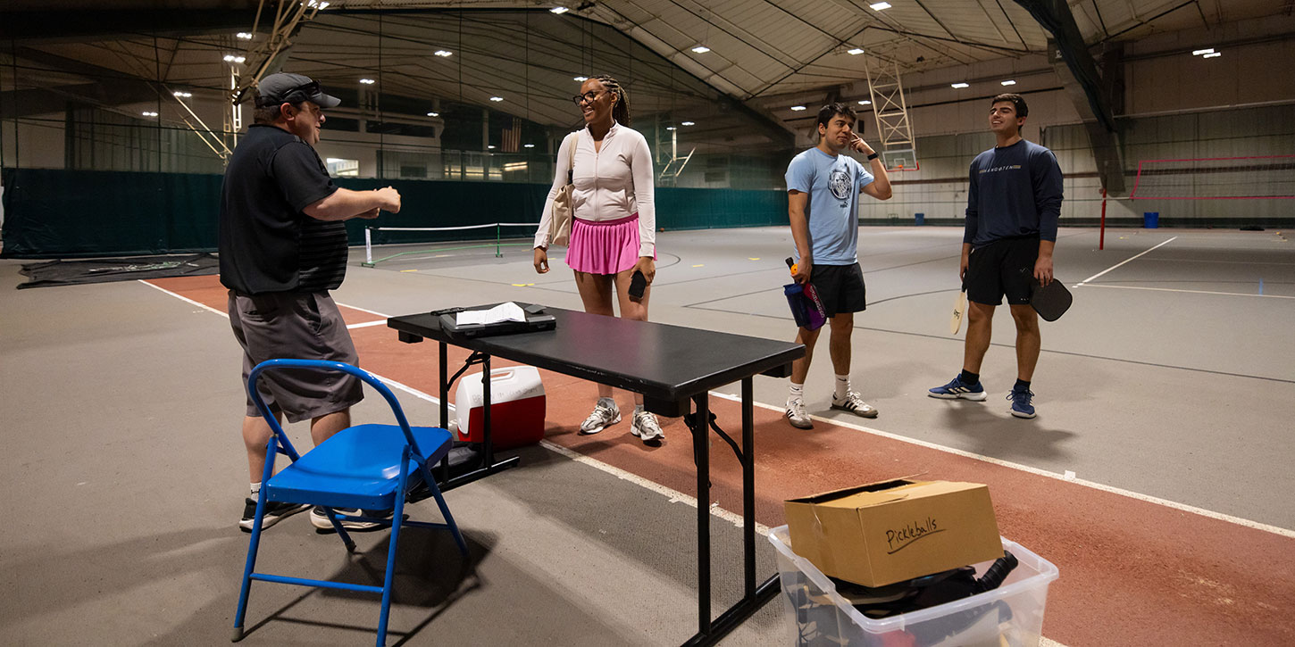 participants of brown recreation's summer intramural leagues have a conversation after a match